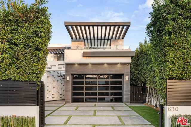 modern home featuring a garage and a balcony