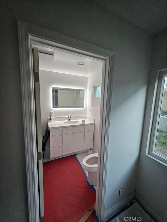 bathroom with vanity and toilet