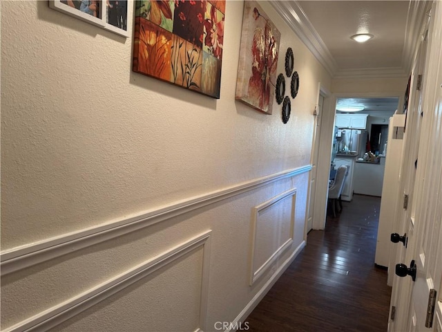 hallway featuring crown molding and dark hardwood / wood-style floors