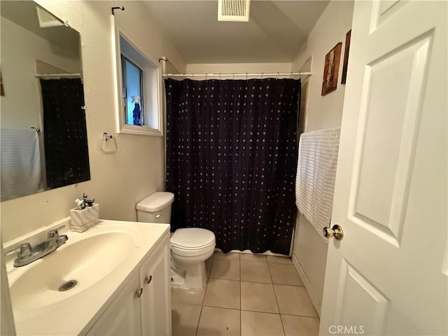 bathroom with toilet, a shower with curtain, vanity, and tile patterned floors