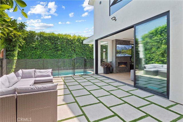 view of patio featuring an outdoor living space with a fireplace