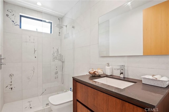 bathroom with vanity, decorative backsplash, toilet, tile walls, and a tile shower