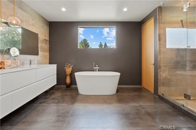 bathroom with vanity, a healthy amount of sunlight, concrete flooring, and separate shower and tub