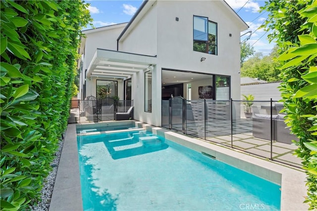 back of house with a fenced in pool and a patio