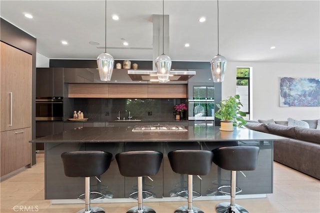 kitchen featuring pendant lighting, stainless steel appliances, and a kitchen breakfast bar