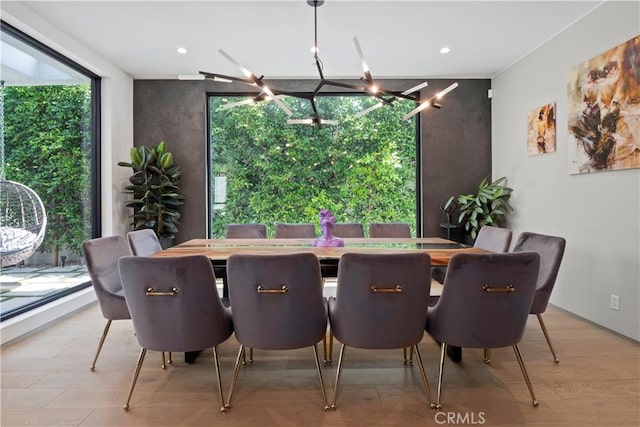 dining room with an inviting chandelier and light wood-type flooring