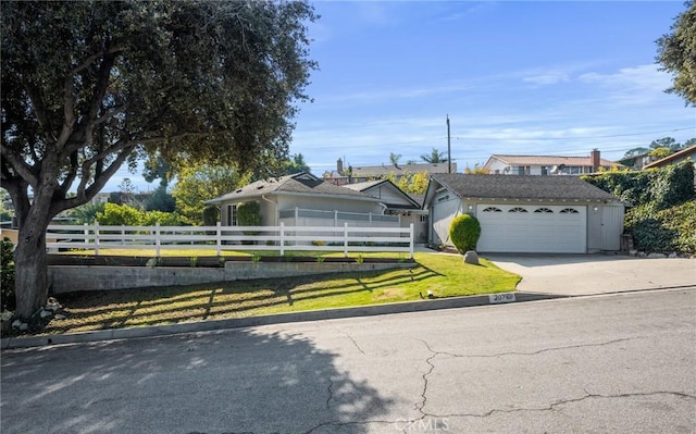 view of front facade with an outbuilding, a garage, and a front yard