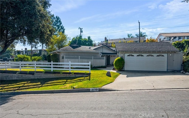 ranch-style house featuring a front lawn and a garage