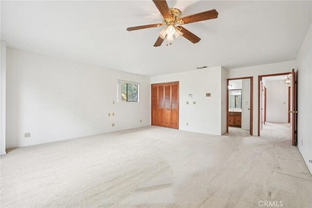 unfurnished room with ceiling fan and light colored carpet