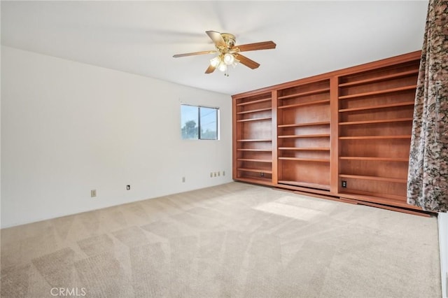 carpeted empty room with ceiling fan