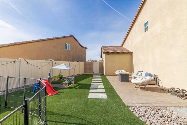 view of yard with a playground and a patio area