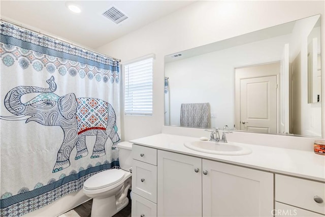 full bathroom featuring shower / tub combo, vanity, and toilet