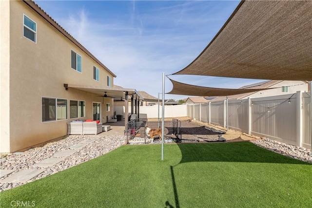 view of yard featuring ceiling fan, an outdoor hangout area, and a patio