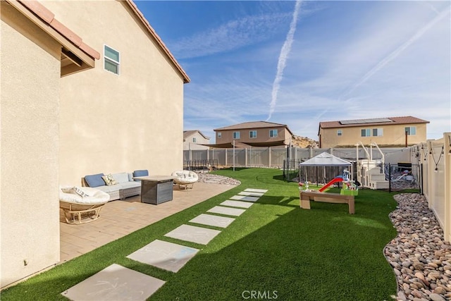 view of yard featuring an outdoor living space, a patio, and a trampoline