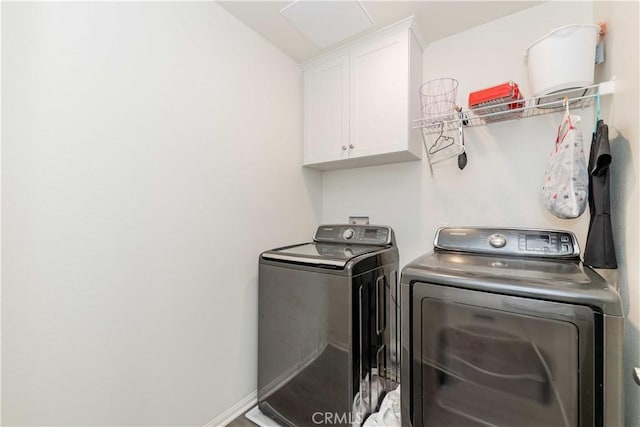 laundry area featuring cabinets and washer and clothes dryer