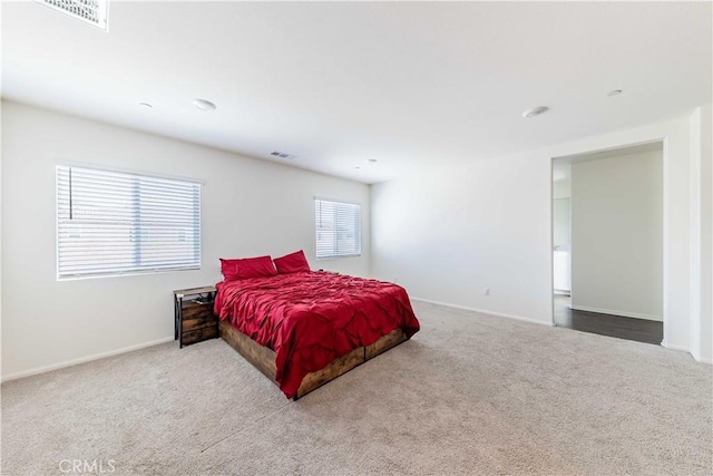 bedroom featuring carpet and multiple windows