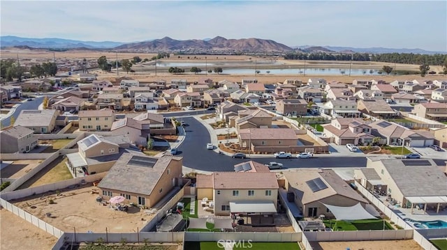 birds eye view of property featuring a water and mountain view