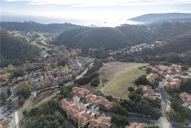 drone / aerial view featuring a water and mountain view