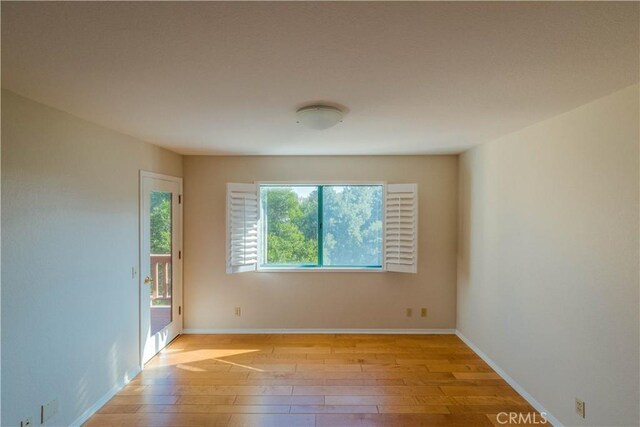 spare room with light hardwood / wood-style flooring