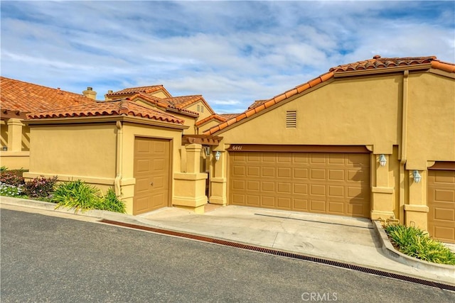 mediterranean / spanish-style home featuring a garage