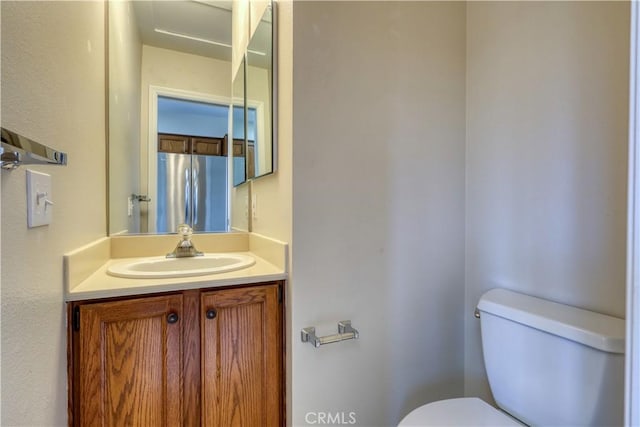 bathroom featuring vanity and toilet