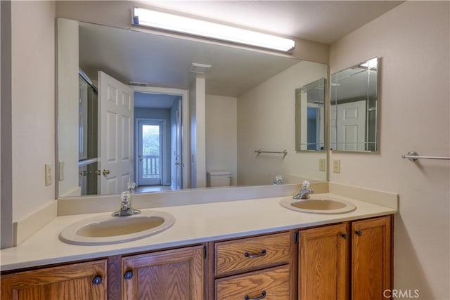 bathroom featuring vanity and toilet