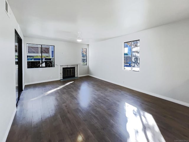 unfurnished living room with ceiling fan and dark wood-type flooring