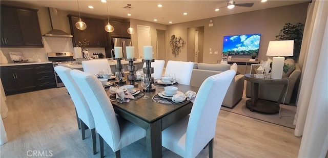 dining room featuring light wood-type flooring and ceiling fan