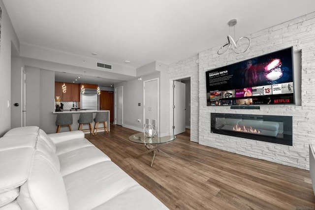 living room with hardwood / wood-style flooring and a fireplace