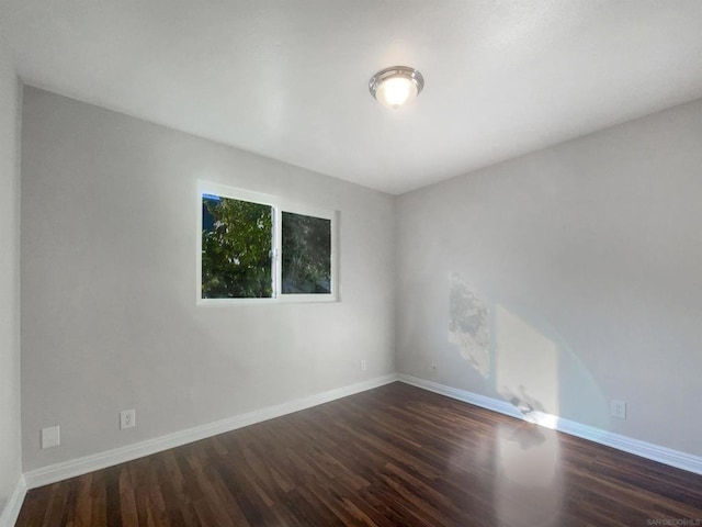 spare room with dark hardwood / wood-style flooring