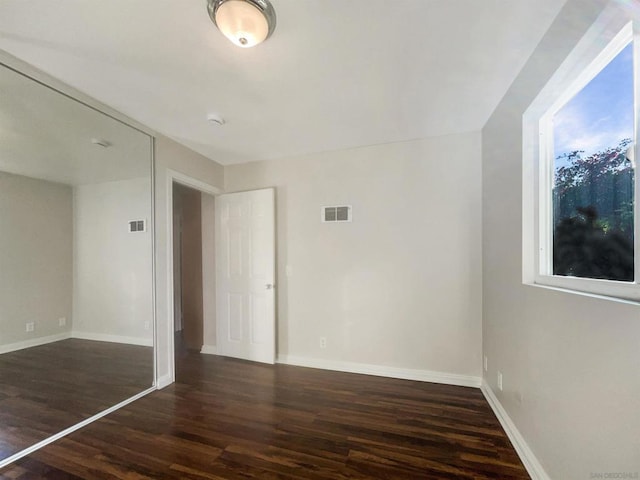 empty room featuring dark hardwood / wood-style flooring