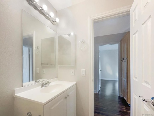 bathroom with hardwood / wood-style floors and vanity