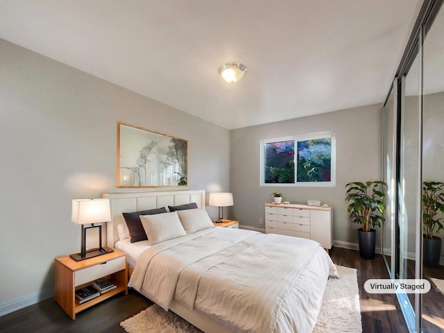 bedroom with a closet and dark hardwood / wood-style floors