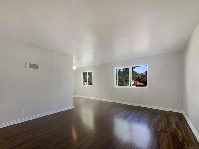 unfurnished living room with dark wood-type flooring