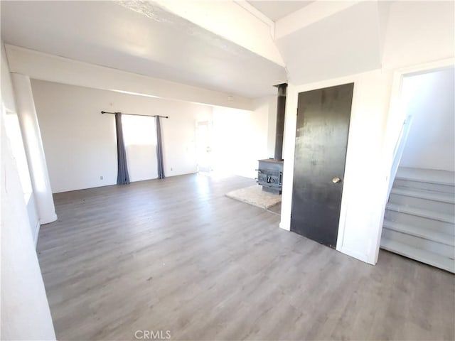 23699 Mclane Ave, Corning, CA 96021 - unfurnished living room with wood finished floors and a wood stove