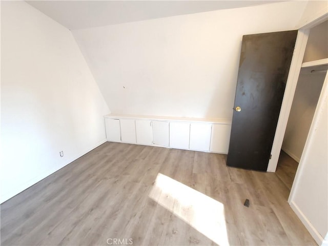 23699 Mclane Ave, Corning, CA 96021 - additional living space with light wood-style floors, vaulted ceiling, and baseboards