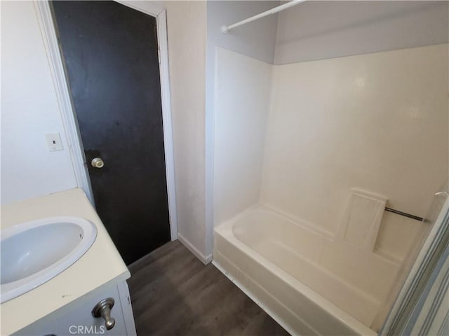 23699 Mclane Ave, Corning, CA 96021 - full bath featuring wood finished floors, vanity, baseboards, and  shower combination