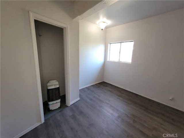 23699 Mclane Ave, Corning, CA 96021 - unfurnished bedroom with dark wood-type flooring and baseboards