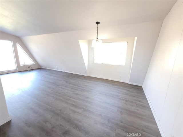 23699 Mclane Ave, Corning, CA 96021 - unfurnished dining area featuring vaulted ceiling, wood finished floors, and baseboards