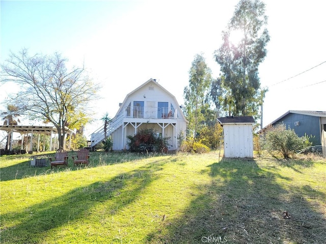 23699 Mclane Ave, Corning, CA 96021 - view of grassy yard with a storage unit, an outbuilding, and a balcony