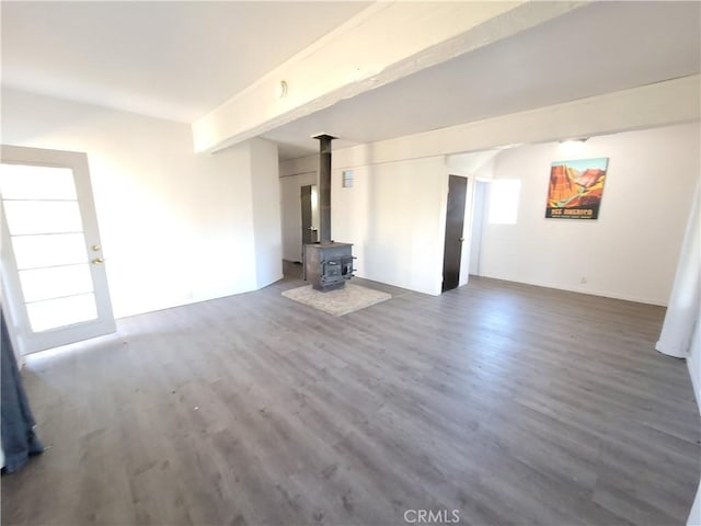 23699 Mclane Ave, Corning, CA 96021 - unfurnished living room with a wood stove and dark wood-style floors