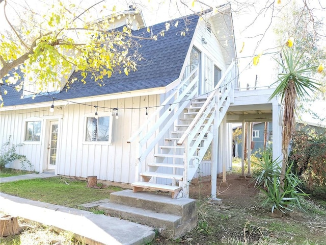 23699 Mclane Ave, Corning, CA 96021 - view of side of property with a shingled roof, stairway, and board and batten siding