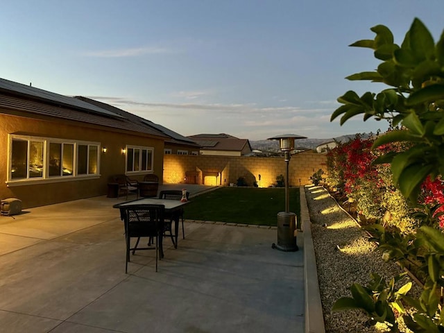 patio terrace at dusk with a yard