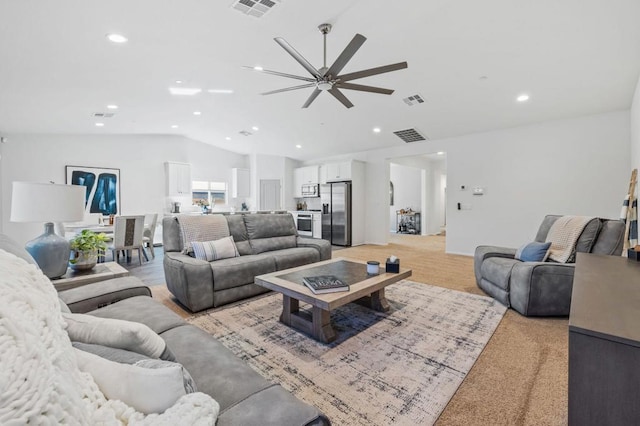 carpeted living room featuring vaulted ceiling and ceiling fan