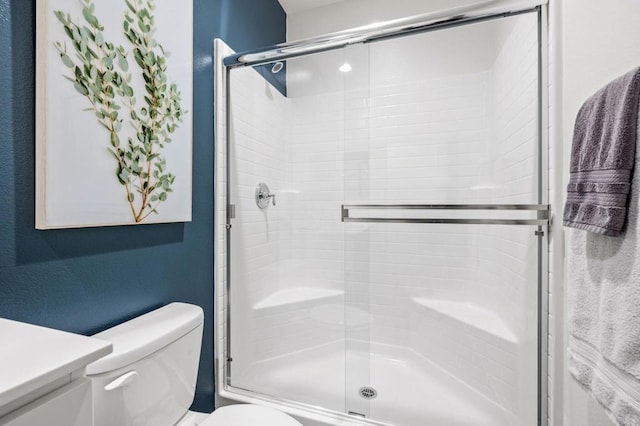 bathroom with vanity, toilet, and walk in shower