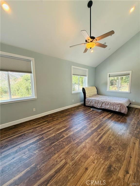 unfurnished bedroom featuring ceiling fan, high vaulted ceiling, and dark wood-type flooring