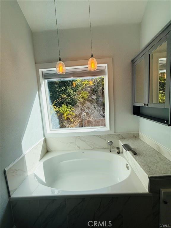 bathroom featuring tiled tub