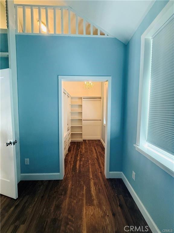 corridor with a healthy amount of sunlight and dark wood-type flooring