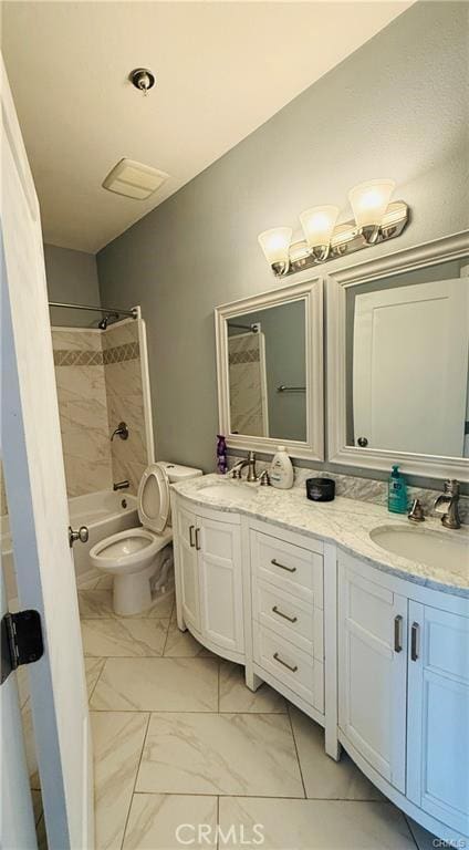 full bathroom with vanity, tiled shower / bath combo, and toilet