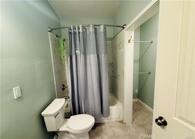 bathroom with tile patterned floors, shower / bath combination with curtain, and toilet